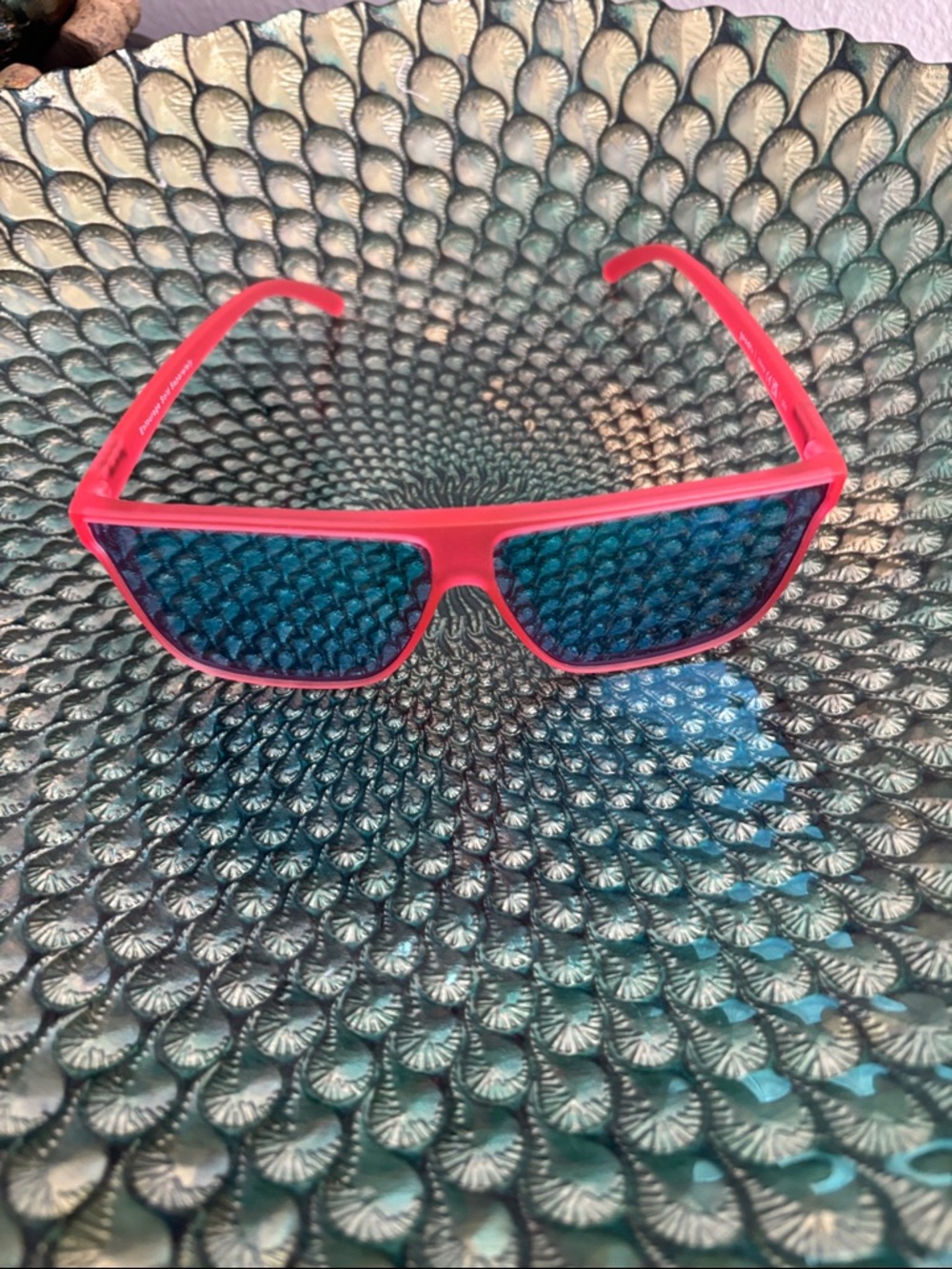 Goodr Fly G sunglasses in red with teal lenses.